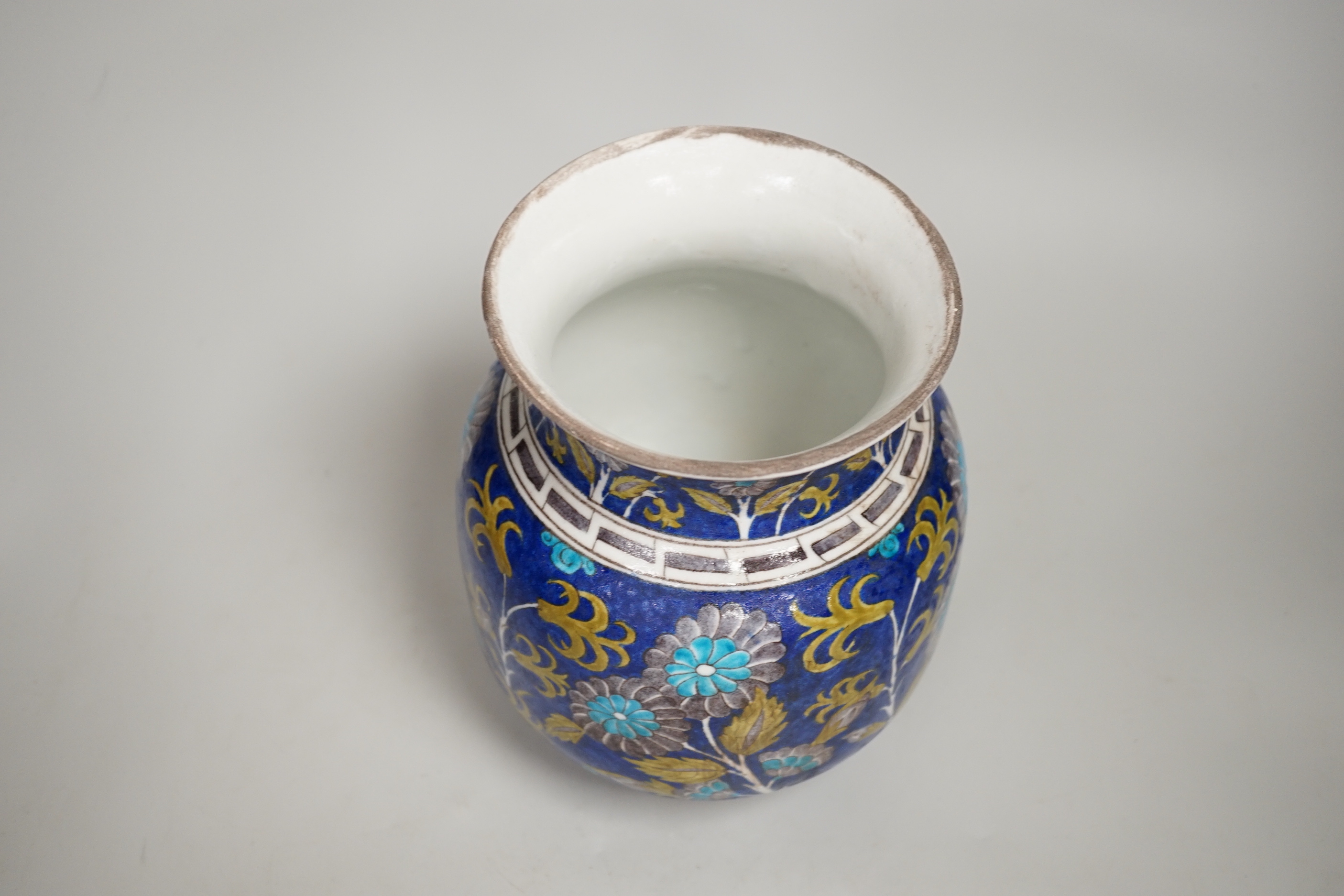 A Turkish Iznik pottery vase, decorated with flowers, 20cm high